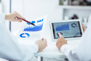 business team using digital tablet, working with the financial schedule of the company's development
