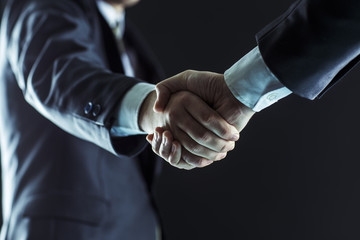 concept of partnership in business: a handshake of business partners. - 143856138