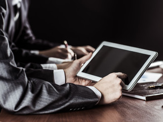 closeup of businessman working with digital tablet at workplace