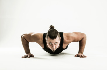 Fototapeta na wymiar coach bodybuilding performs push-UPS.photo on a white background