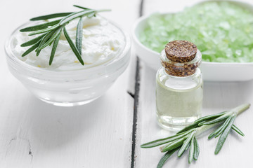 organic cosmetics with rosemary extract on wooden table background