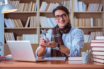 Young book writer writing in library
