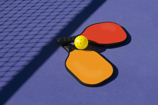 Pickleball Paddles and Ball(s) On Court