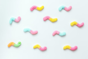 Colorful candies on white texture background top view pattern