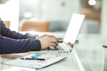 financial managers working on laptop with financial data at the workplace in a modern office