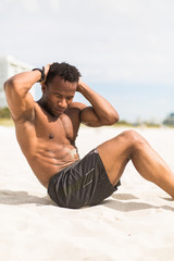 Muscular Black man exercised on the beach