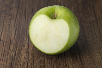 green apple on wooden table - Heart shape