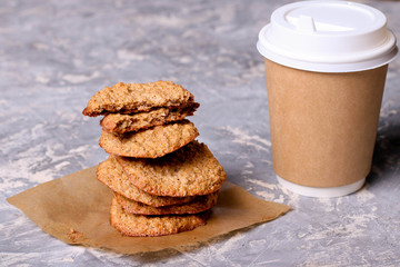 Paper cup of coffee and cookies