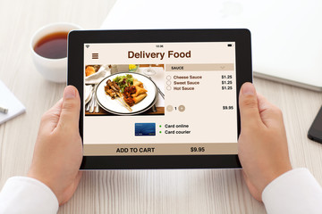 man hands holding tablet with app delivery food on screen