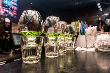 Glasses with absinthe set in bar