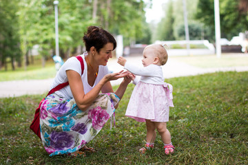 Small cute baby and nice mom outdoors