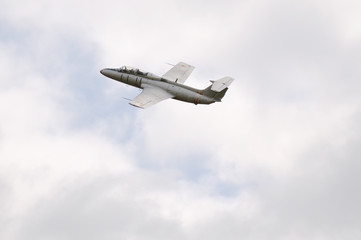 Fototapeta na wymiar Jet aircraft in cloudy sky