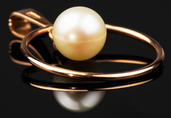 Golden pendant on black