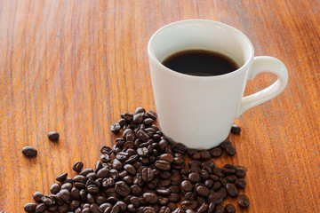 Coffee cups and coffee beans on wooden boards