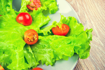 Vegetables and salad on the wooden table. Toned image