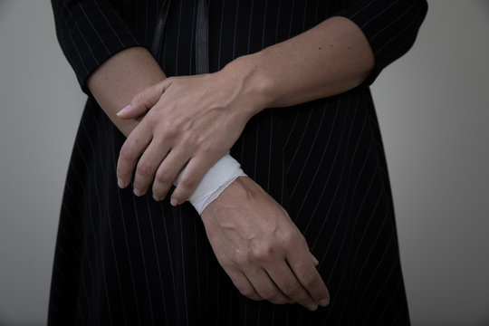 Middle age woman showing her bandaged wrist.