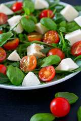 Vegetarian salad with cherry tomato, mozzarella and rucola