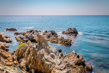 panoramic view of seashore with rock cliff