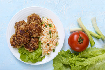 Hamburgers with juicy cutlet, tomatoes, pickled cabbage and cucumbers, cheese, green lettuce leaves and a soft bun with sesame