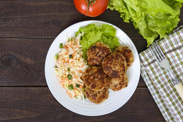 Hamburgers with juicy cutlet, tomatoes, pickled cabbage and cucumbers, cheese, green lettuce leaves and a soft bun with sesame