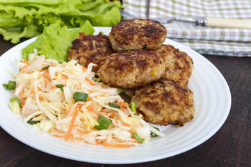 Hamburgers with juicy cutlet, tomatoes, pickled cabbage and cucumbers, cheese, green lettuce leaves and a soft bun with sesame