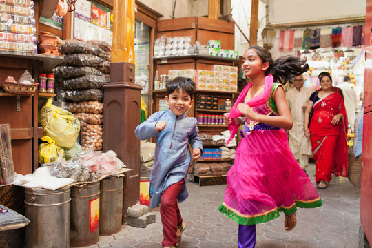 Children running at street market.