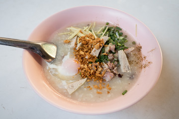Thai rice porridge with egg and pork sausage