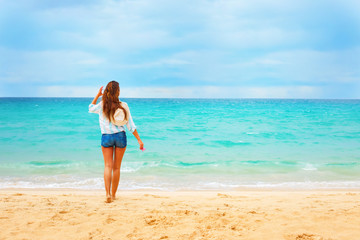 Fototapeta na wymiar Beautiful Young Woman Looks on Blue Sea Summer