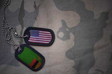 army blank, dog tag with flag of united states of america and zambia on the khaki texture...