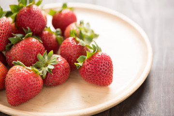 Fresh red strawberries on old wooden background