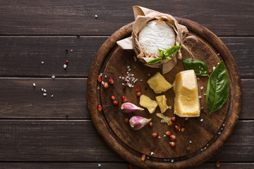 Cheese delikatessen closeup on rustic wood, brie and parmesan