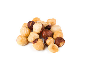 Pile of roasted hazelnuts close-up isolated on white background