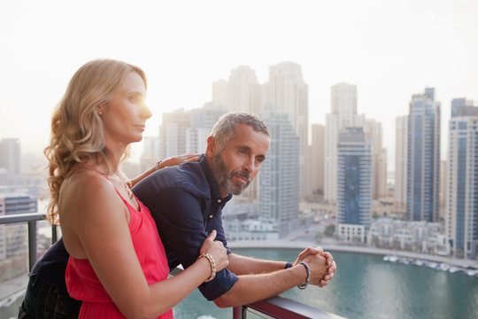Couple looking out from balcony.