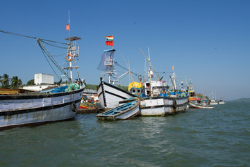 Noon in the fishing port. Parking of fishing boats in India
