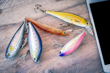 Colorful fishing lures on the wood table