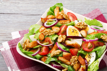 Delicious salad with chicken, nuts, egg and vegetables.