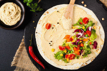 Tortilla with vegetables and hummus with chickpeas