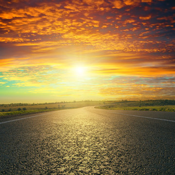 Fototapeta red sunset over asphalt road
