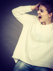 Unhappy woman screaming and yelling in pain