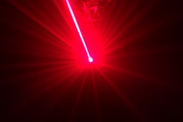Green and red laser in a nightclub. Laser beams on a dark background, club atmosphere
