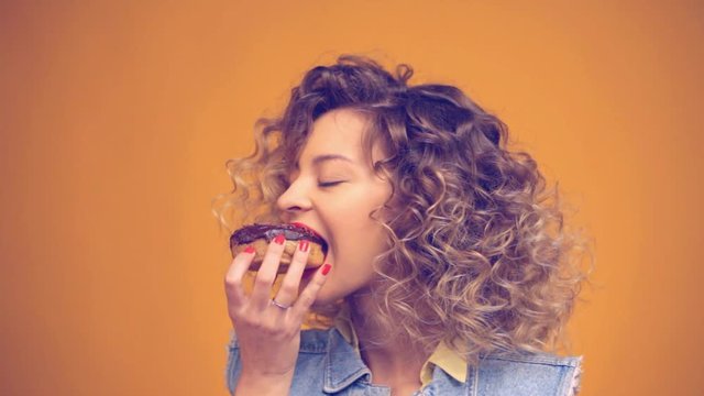 girl with pleasure bites the donut