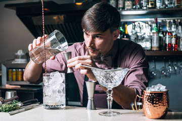 The barman prepares drinks in the club behind the bar