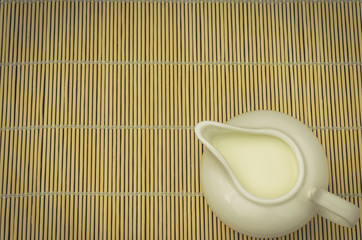 creamer on a straw napkin/creamer on a straw napkin. Top view