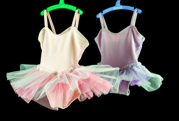two tutu for baby on colored hangers