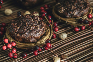 Chocolate Muffins on rustic background.