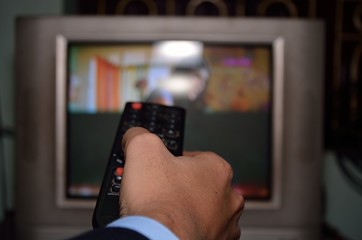 Man control television with remote.