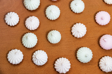 Meringue pattern on wooden background. Top view