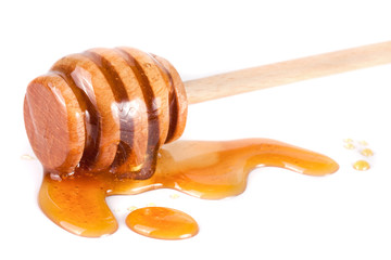Honey stick with flowing honey isolated on white background