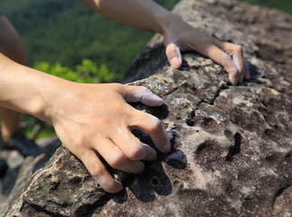 success young woman rock climber on mountain peak