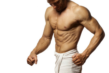Obraz premium half-naked handsome and muscular young man with towel around his waist posing on a white background